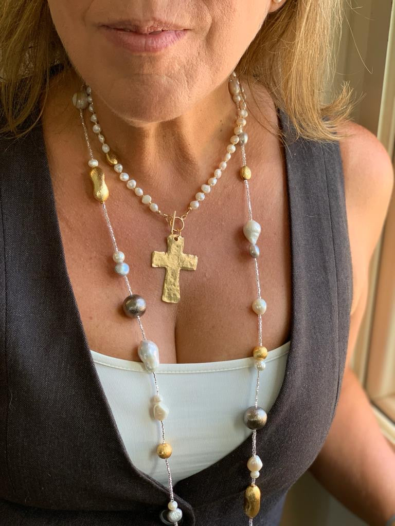 white pearl necklace with gold plated cross